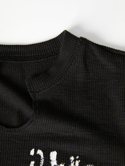 Crop top noir à manches longues avec motif graphique